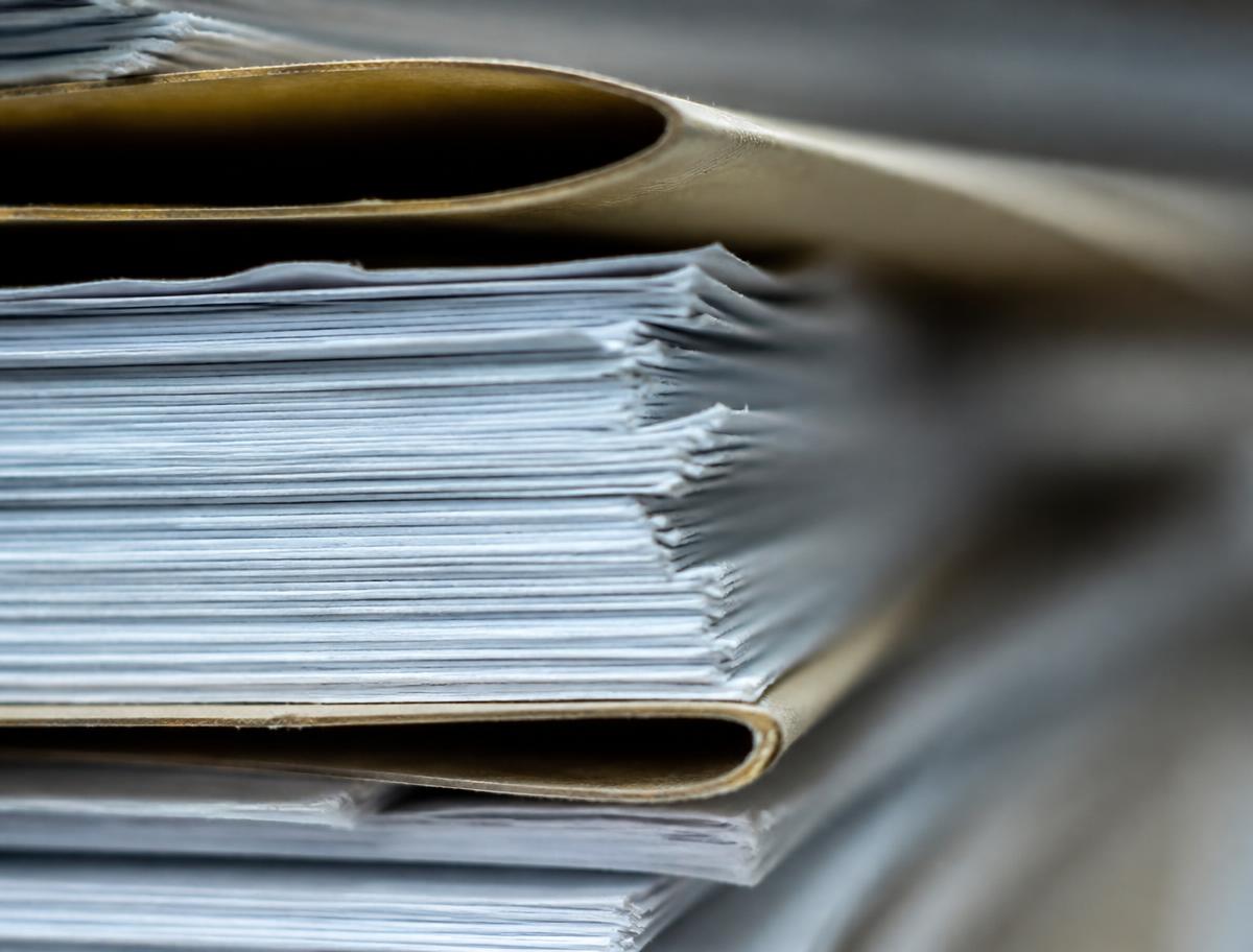 Stacked ledger paper in raking light