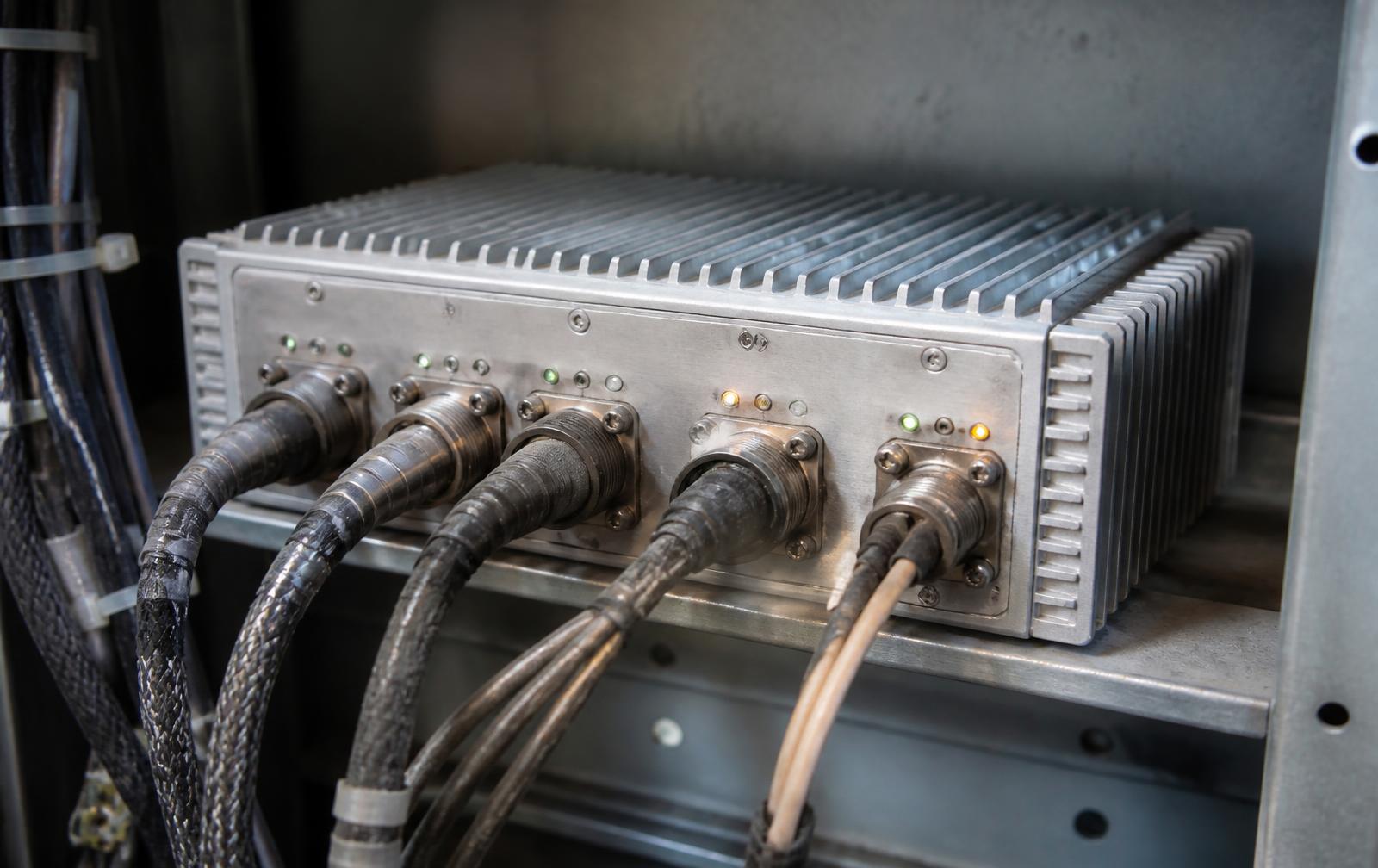 Ruggedized edge compute enclosure wired into an industrial cabinet